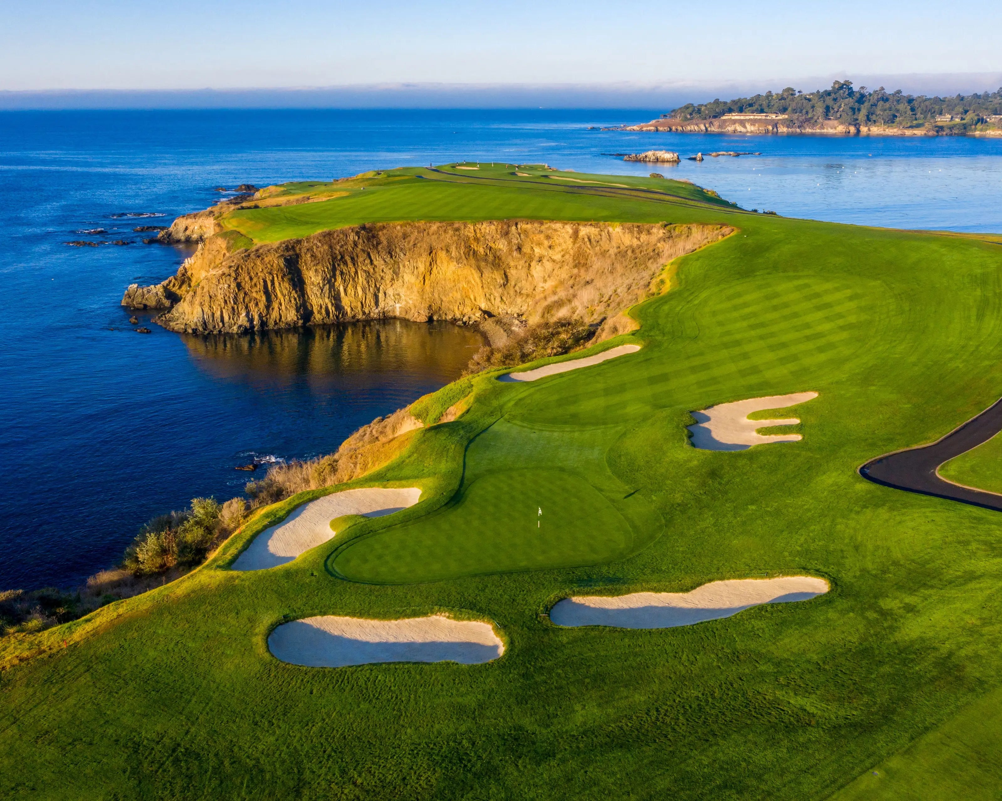 Cliffside green at Pebble Beach Golf Links overlooking the Pacific Ocean.