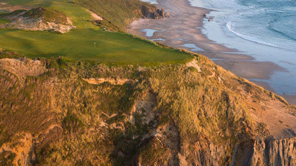 Aerial view of the Sheep Ranch golf course perched on dramatic oceanfront cliffs along the Oregon coastline.